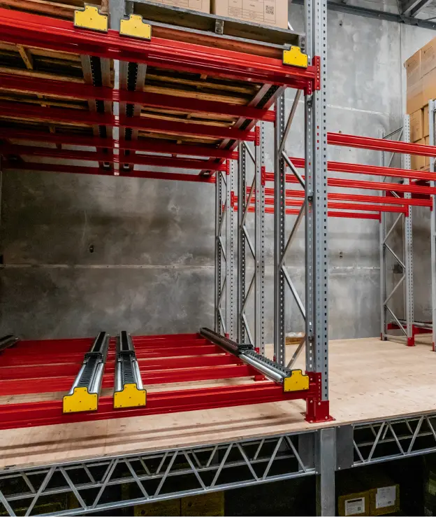Push-back pallet racking with spring rail system for high-density warehouse storage